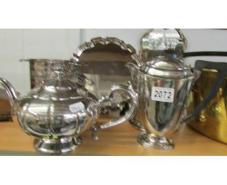 A silver plate tray, teapot, coffee pot and two wine bottle stands.