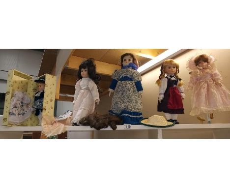 A shelf of collectors dolls 