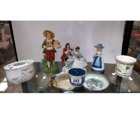 A shelf of decorative porcelain figurines etc.