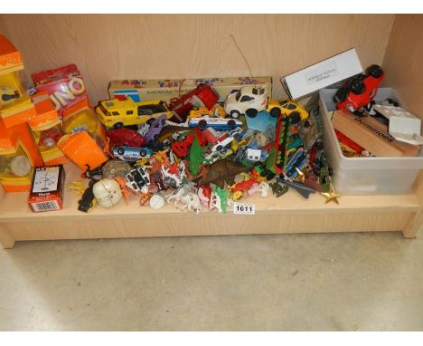 A shelf of vintage plastic and other toys. 