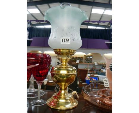 A brass oil lamp with green tinted tulip shade 