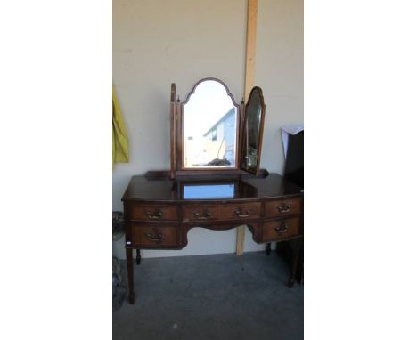 A mahogany bow front dressing table. COLLECT ONLY.