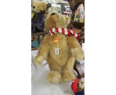 A Steiff classic original bear with red and white scarf.