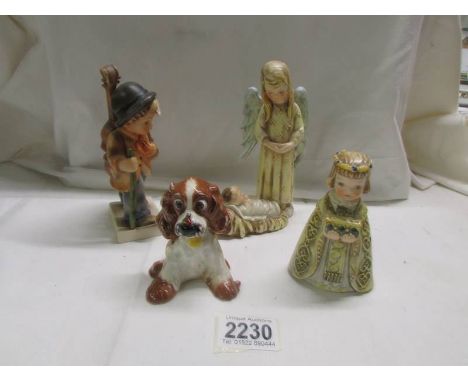 A Goebel dog, a Goebel boy with cello, A Gobel Angel with baby Jesus and another Goebel figure. 