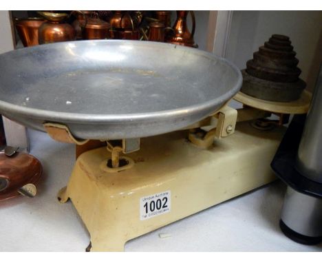 An old set of kitchen scales with weights 