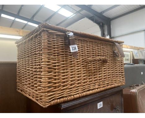 A wicker hamper basket 