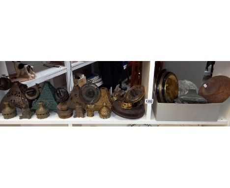 A large shelf of oil lamp parts 