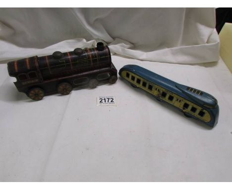 A rare Wells Brimtoy tin plate clockwork 'Golden Streak' streamline train and a Japanese tinplate C.tc? whistling train. 