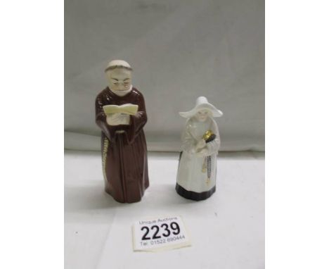Two Royal Worcester candlesnuffers, a monk and a nun. 