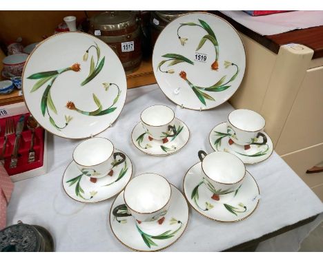An interesting set of 5 cups and saucers and 2 cake plates feature a raised relief snowdrop design and stalks for feet on the