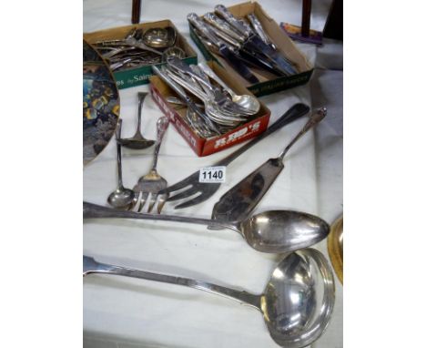 A collection of silver plate cutlery including ladle 