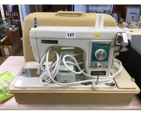 A cased 'Consul' typewriter and a cased 'New Home' sewing machine