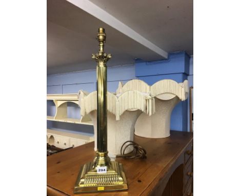 A brass standard lamp and matching table lamp, with shades