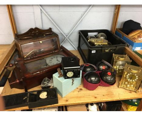 A shelf of assorted, including lawn bowls, wall clock, carriage clocks etc.