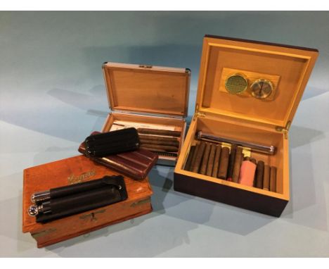 An oak cigar box, two humidors, two cigar cases and a hip flask and cigar case