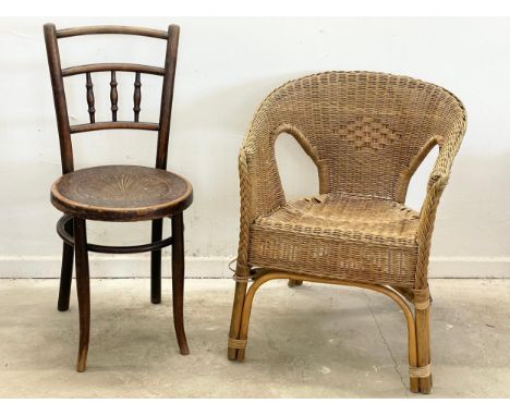 An early 20th century Thonet Bentwood chair with pokerwork seat and a vintage wicker armchair. 