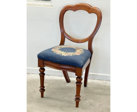 A Victorian mahogany balloon back side chair with tapestry seat. 