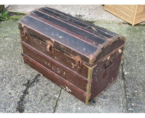 A large early 20th century dome top trunk with DVD’s. 
