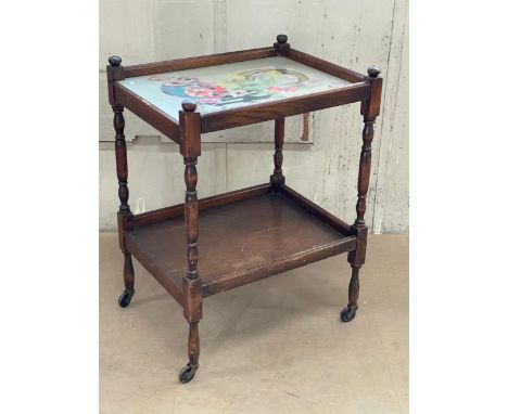 A vintage oak 2 tier trolley with tapestry and glass top. 