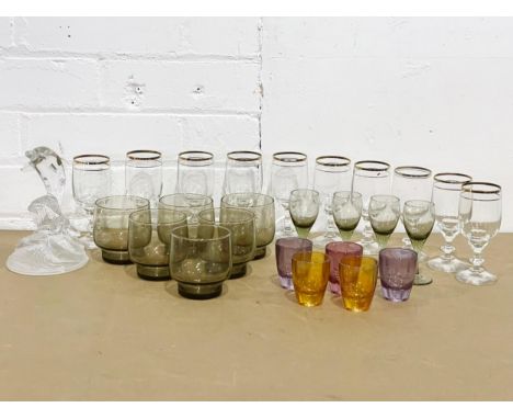 A quantity of vintage drinking glasses and a French crystal dolphin. 