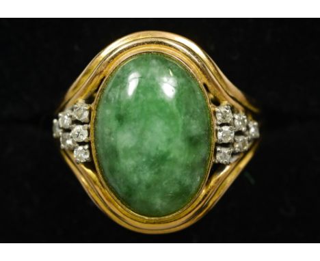 A 14 ct gold jade and diamond set ring
The central cabochon jade stone flanked by small diamonds. CONDITION REPORTS: Overall 