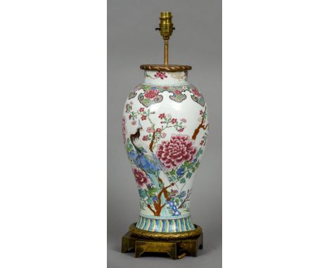 A Chinese porcelain baluster vase
Decorated with exotic birds amongst floral sprays interspersed with butterflies, drilled fo