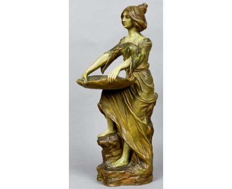 A late 19th century Austrian pottery calling card tray
Modelled as a young lady holding a lily pad, standing on a naturalisti