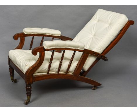 A 19th century walnut framed reclining plantation chair
The turned ladder back above the twin padded open arms with turned up