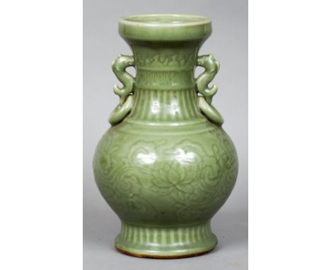 A large Chinese celadon vase
Of ovoid form with twin dolphin and ring handles, the main body with floral decoration.  30 cm h