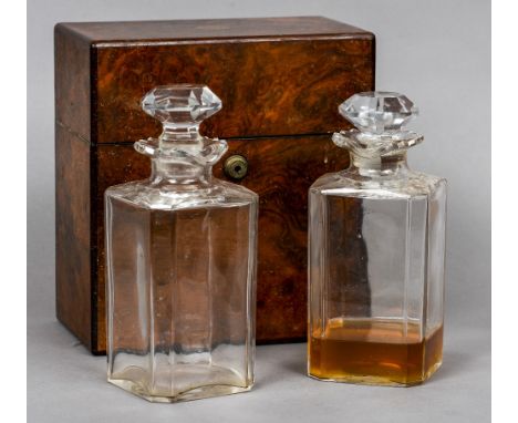 A 19th century burr walnut decanter box
The rectangular hinged cover enclosing a pair of cut glass decanters and stoppers.  2