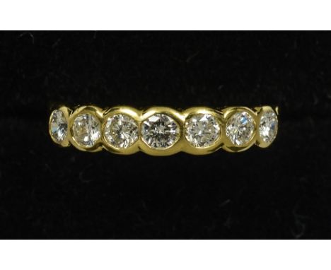 An 18 ct gold seven stone diamond ring
Of band form, with pierced shoulders.   CONDITION REPORTS: Overall good, some general 