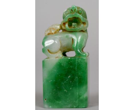 A Chinese carved jade seal
Carved with a dog-of-fo.  6 cm high. CONDITION REPORTS: Some pitting, natural cracks, general wear