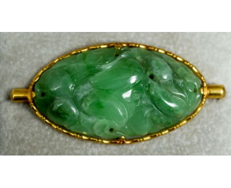 A Chinese predominantly apple green coloured jade brooch
The high carat gold  mount impressed with numerous seal marks.  5.25