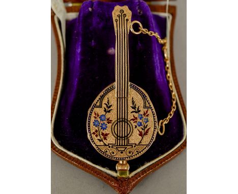 An enamel decorated 18 ct gold watch
Formed as a mandolin, the white enamel dial with Roman and Arabic numerals, the case wit