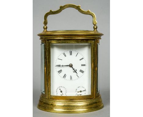 An oval gilt brass cased French striking carriage clock
The white enamel dial with Roman numerals, with subsidiary day and da
