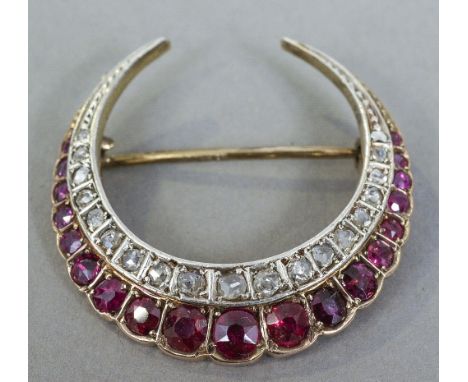 An unmarked gold, diamond and ruby set crescent form brooch
3 cm wide. CONDITION REPORTS: Some surface wear to stones, genera