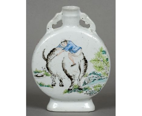 A Chinese porcelain moon flask
Decorated with a boy riding a water buffalo opposing deer and calligraphic script, red painted