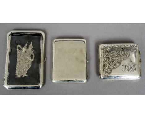 A Russian silver cigarette case, stamped for 84 Zolotniks, maker's mark of BH
Set with a green cabochon stone button; togethe