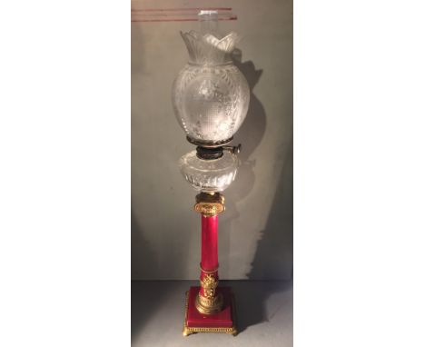 A 19th century Anglo-Russian gilt metal mounted ox-blood porcelain oil lamp
The etched shade above a glass reservoir, support