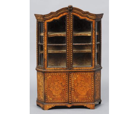 A late 18th/early 19th century Dutch floral marquetry inlaid oak miniature cabinet
The arched pediment above twin glazed door