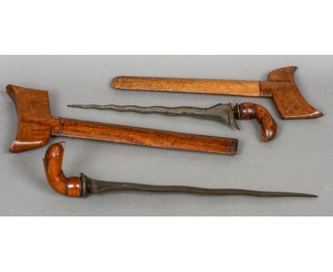 Two Indonesian kris
Each with carved wood handle, typically shaped blade and wooden scabbard.  The largest 43 cm long overall