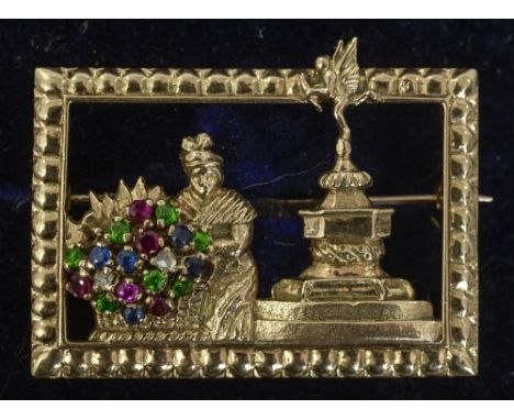 An unmarked gold, diamond, ruby, sapphire and green garnet set brooch
Formed as a scene of Piccadilly Circus with a flower se