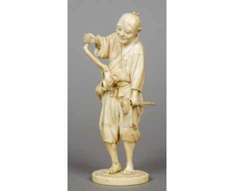 A 19th century Japanese carved ivory okimono
Formed as a farmer holding an axe and a flower, the underside signed.  17.5 cm h