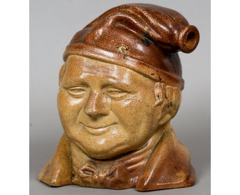 A 19th century salt glaze character mask flask
Of large proportions, modelled wearing a bow tie.  26 cm high. CONDITION REPOR