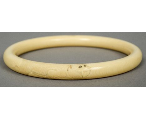 A Japanese carved ivory bangle
Decorated with twin monkeys.  10.5 cm diameter.  CONDITION REPORTS: Generally in good conditio