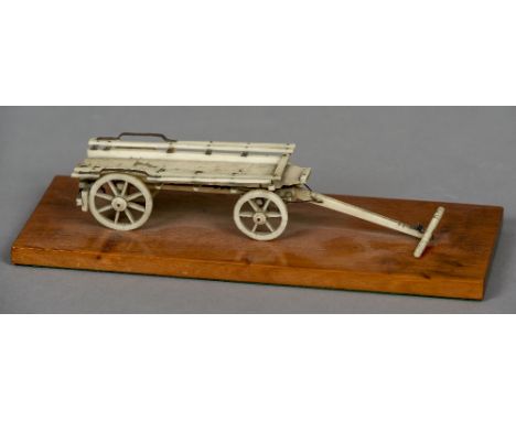 A 19th century Prisoner of War bone model of a cart
Mounted on a later mahogany plinth base.  25.5 cm long overall. CONDITION