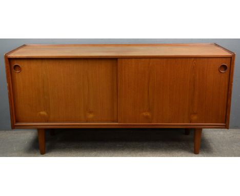 Attributed to Arne Hovmano Olsen for Mogens Kold, a Danish teak side board, with three quarter gallery, above two sliding doo