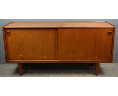 Attributed to Arne Hovmano Olsen for Mogens Kold, a Danish teak side board, with three quarter gallery, above two sliding doo