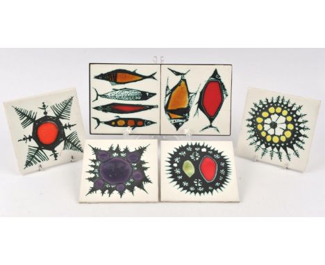 Kenneth Clark tiles, four tiles with abstract coloured designs, printed marks to backs, 15cm square, together with a pair of 