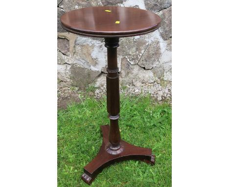 A Regency mahogany lamp table, the top with double reeded edge on a turned and facetted column, with platform base terminatin